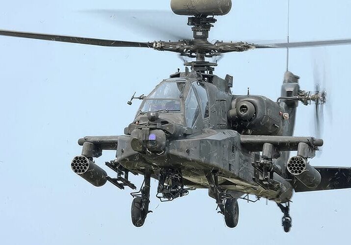 A helicopter with its landing gear down and the front of it.